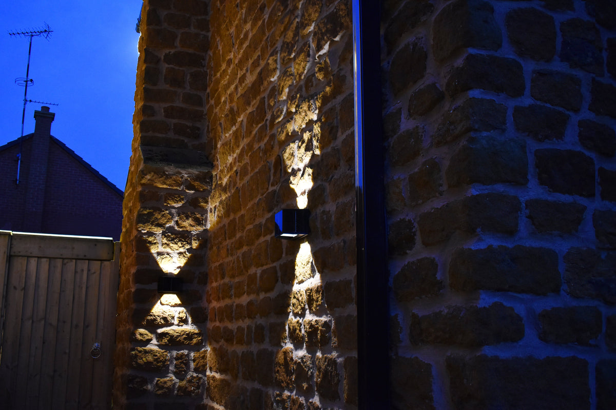 Aptrix solar wall lights illuminating a stone property