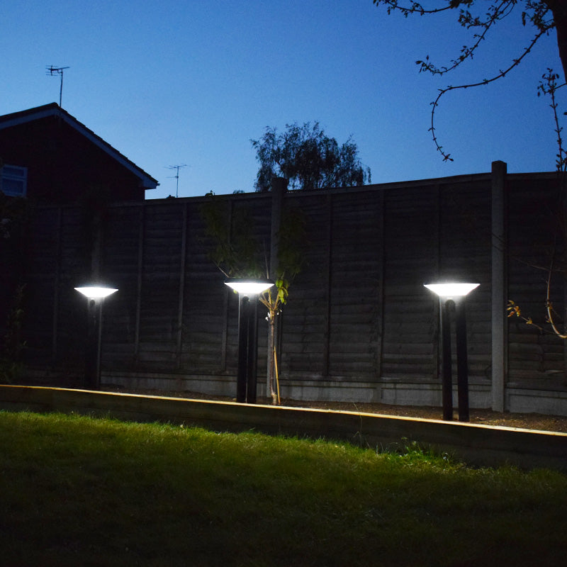 Arc daylight-white solar path lights operating at dusk