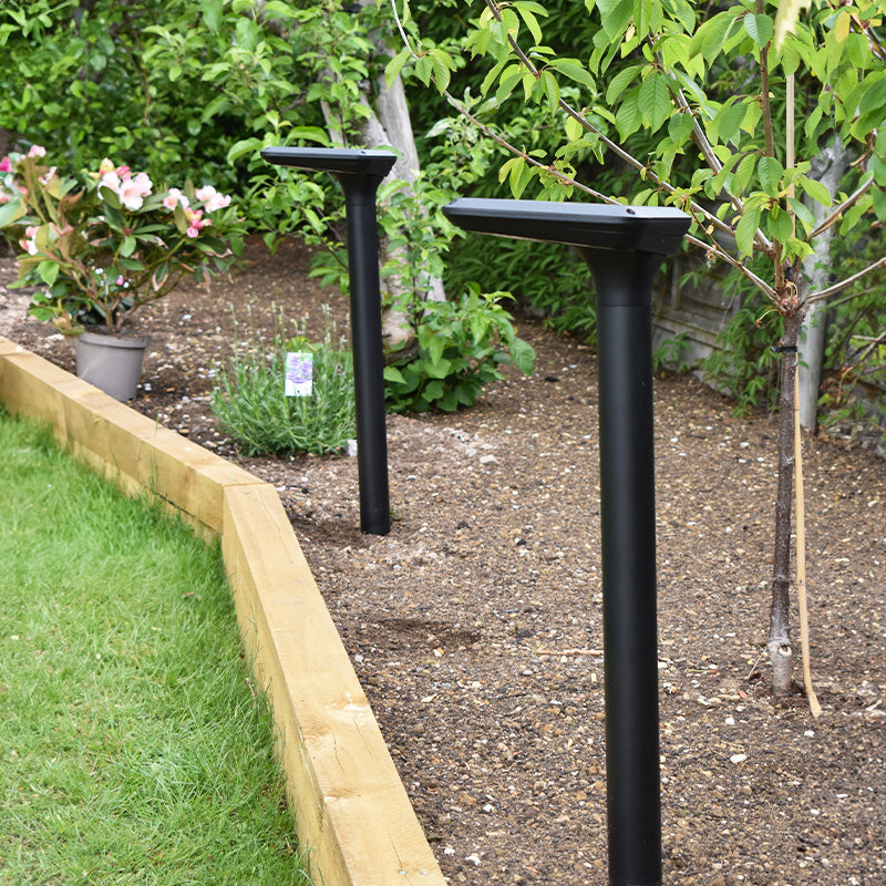 Bastion solar post lights installed in a garden during daytime