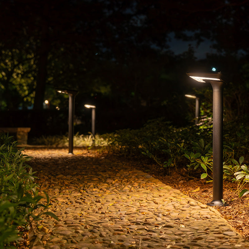 Bastion solar post lights illuminating a path at night