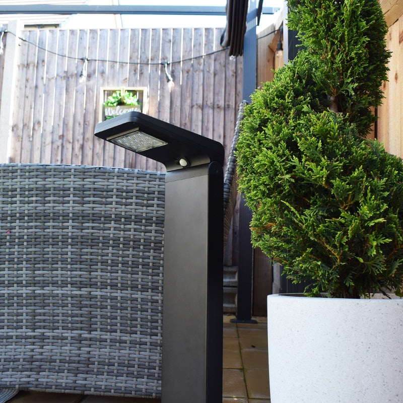 Cresta PIR solar path light beside a garden seating area