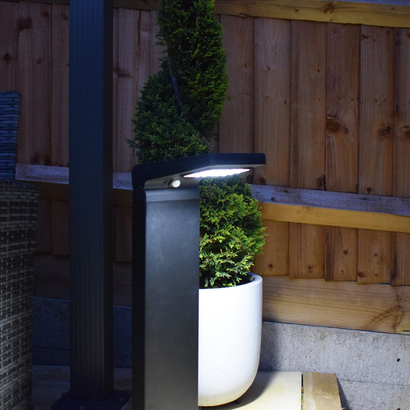 Cresta PIR solar bollard illuminating a garden area