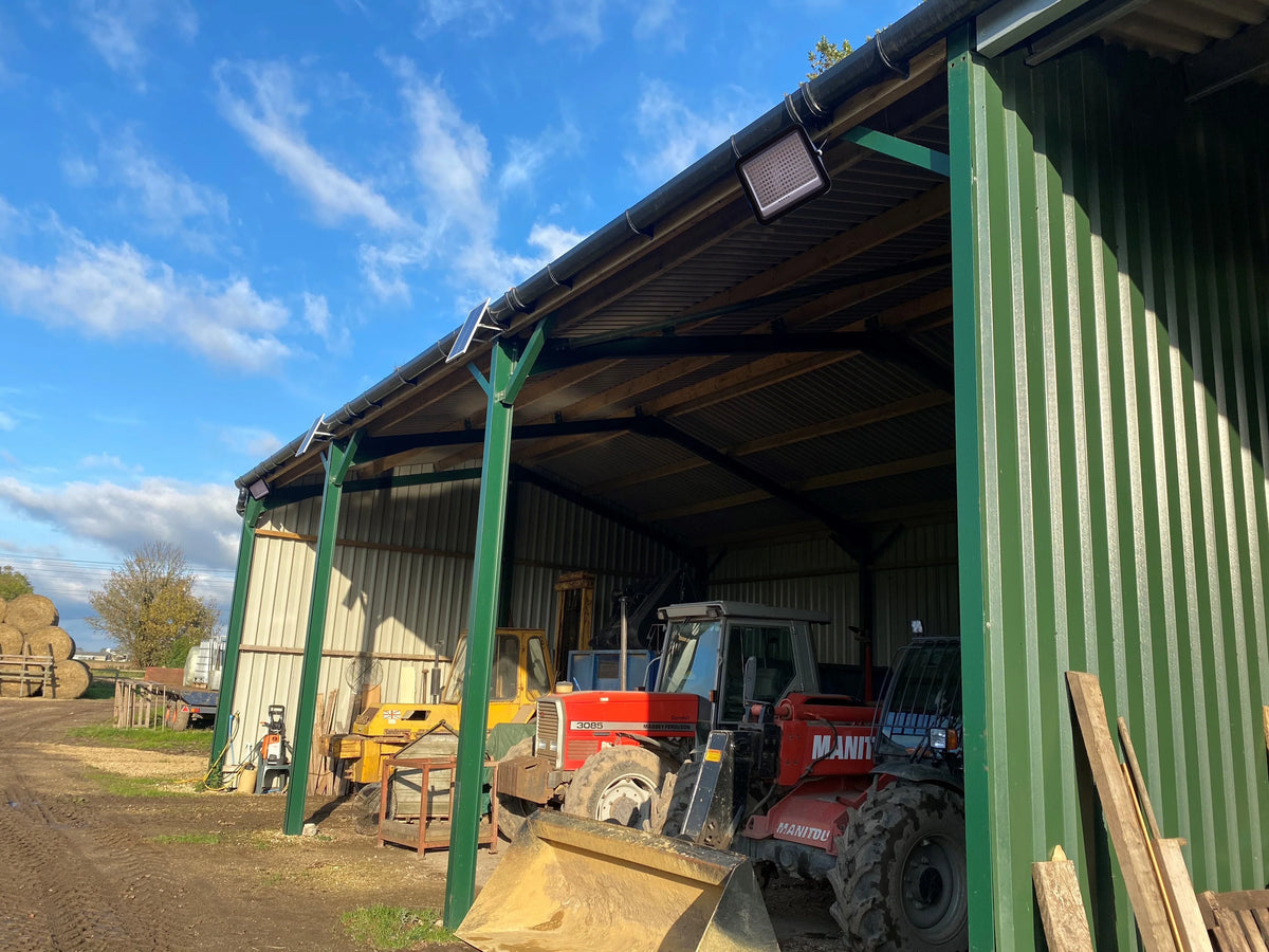 Heliosol solar floodlights installed on a rural machinery building
